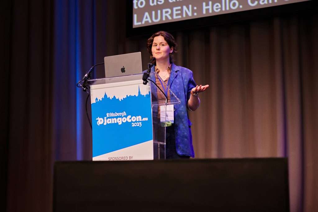 Lauren giving a speech to a large audience Lauren giving a speech to a large audience