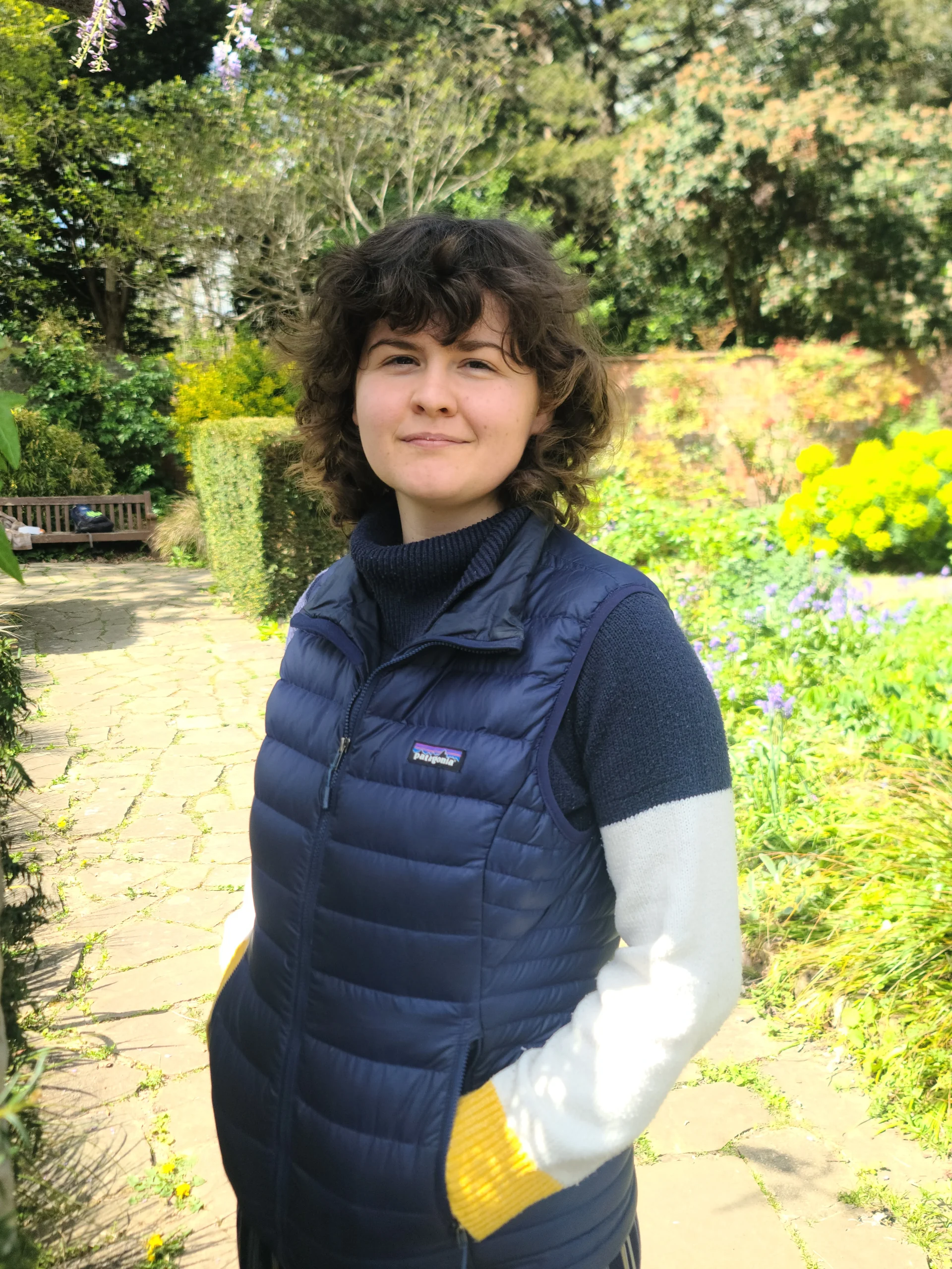 Lauren standing in a garden, smiling