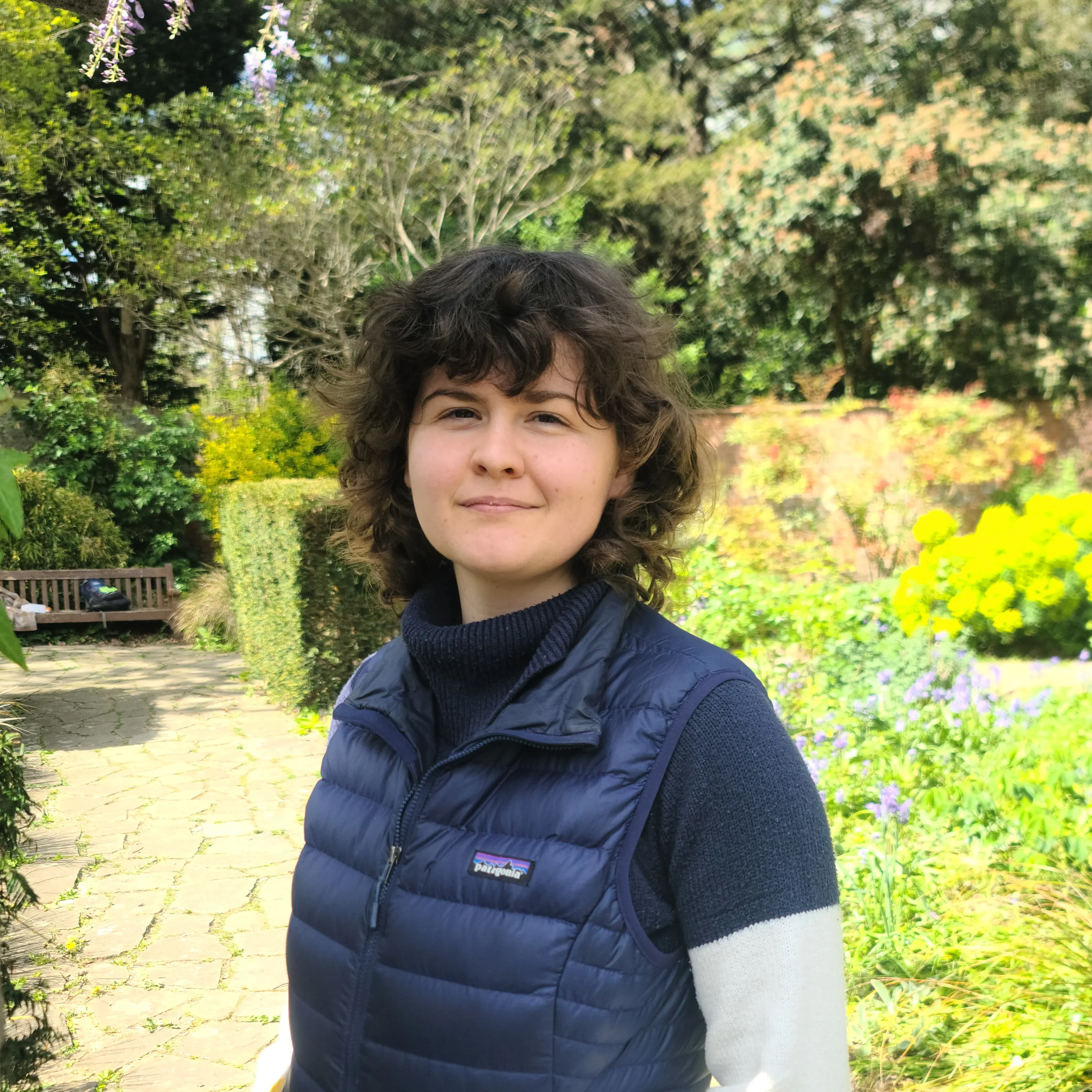 Lauren standing in a garden, smiling